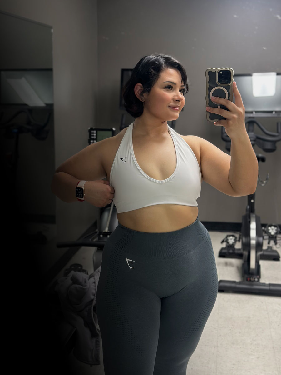 The coach is posing at the gym.