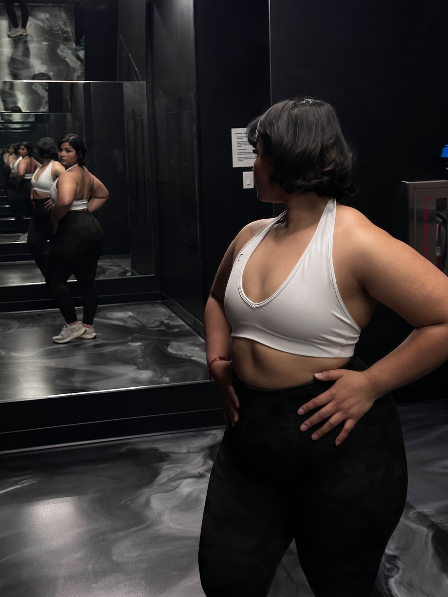 The coach is posing while looking at the mirror.